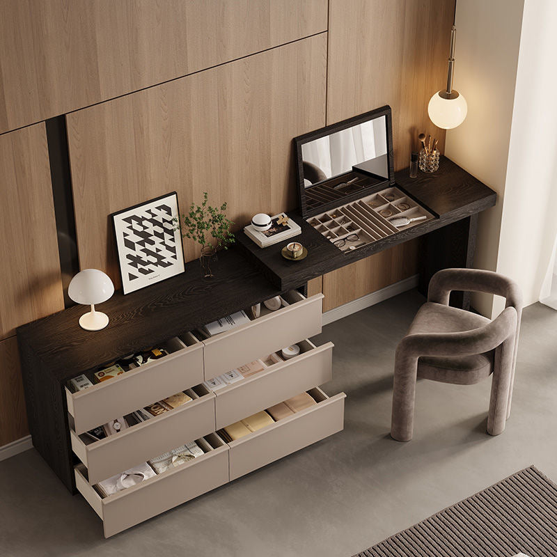 Angled view of the Ovela vanity and dresser combo with all six beige drawers pulled open to show storage capacity for makeup and clothes.