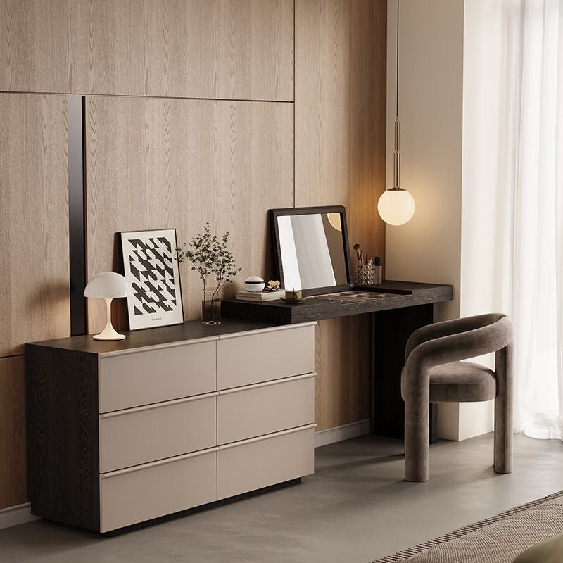 Angled view of the Ovela modern makeup vanity and dresser styled in a bedroom, featuring the open flip-up mirror and a plush velvet chair.