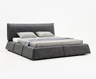 Paris Elegance Grey Platform Bed with low modern frame and soft cushioned headboard on white studio background