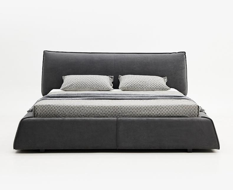 Paris Elegance Grey Platform Bed with plush upholstered headboard and patterned bedding on white studio background