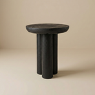 Ryn side table in a matte black wood finish with a round top and sculptural tripod base.