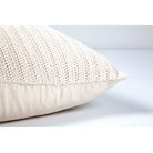 Side profile view of the plush Sadie knit pillow showcasing its chunky textured front and smooth neutral backing.