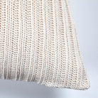 Close-up of the corner and thick ribbed knit texture on the cream Sadie throw pillow.