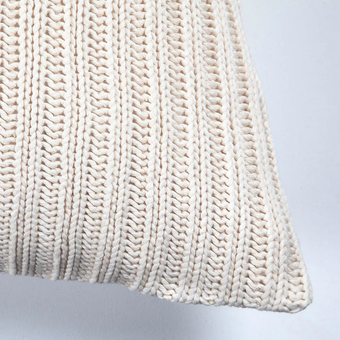 Close-up of the corner and thick ribbed knit texture on the cream Sadie throw pillow.