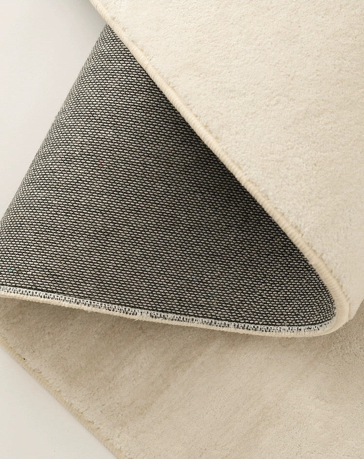 Close-up of the Sandstone Elegance Rug showing soft beige surface and durable woven backing