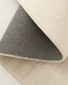 Close-up of the Sandstone Elegance Rug showing soft beige surface and durable woven backing