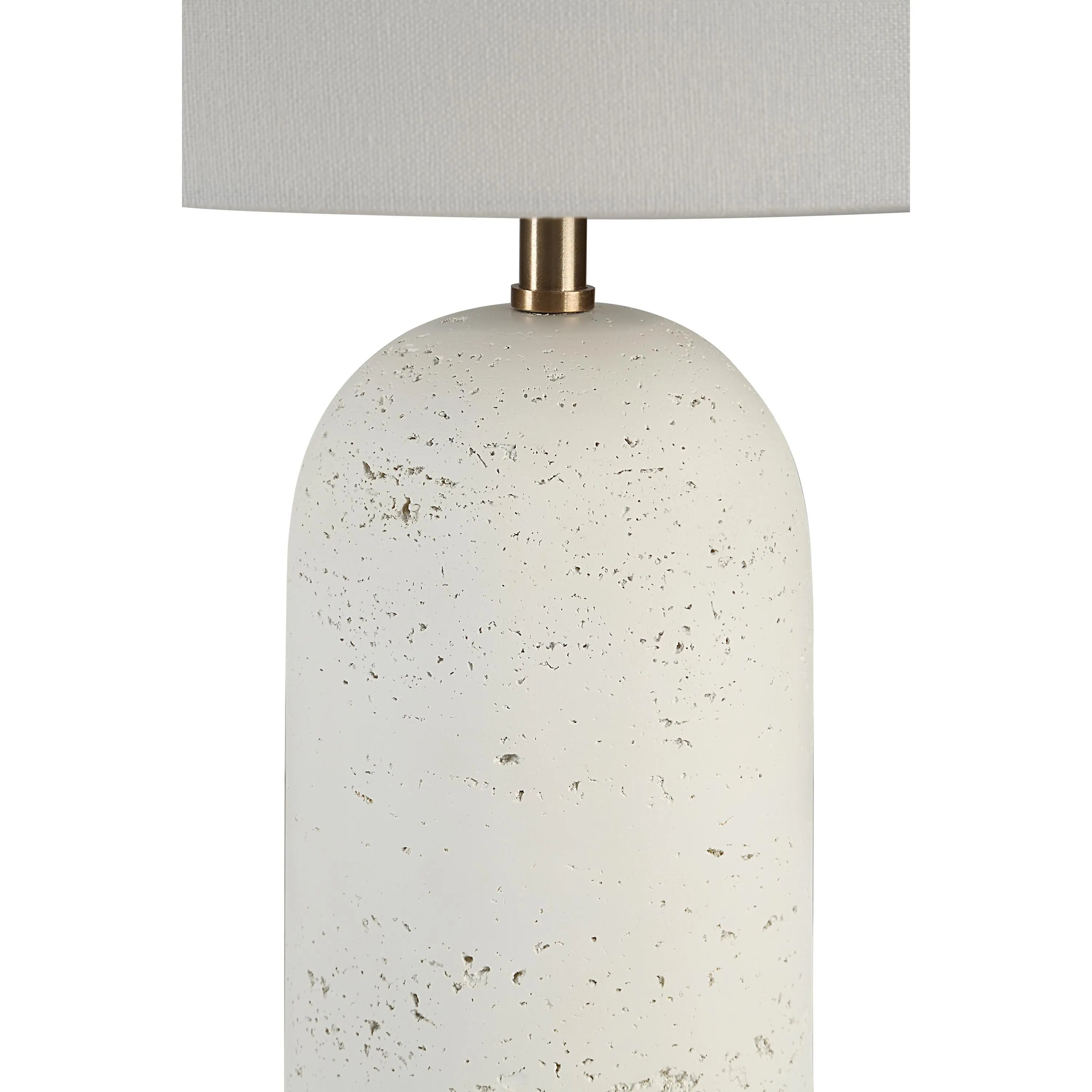 Close-up of Sienna Sculpted Table Lamp showing textured ceramic base with brass accent and fabric shade