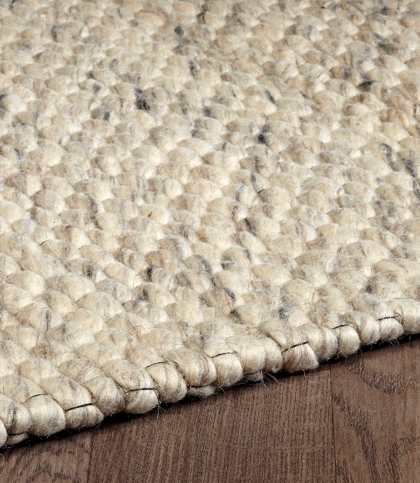 Angled close-up highlighting the thick, woven loop texture of the Silas wool rug in ivory.