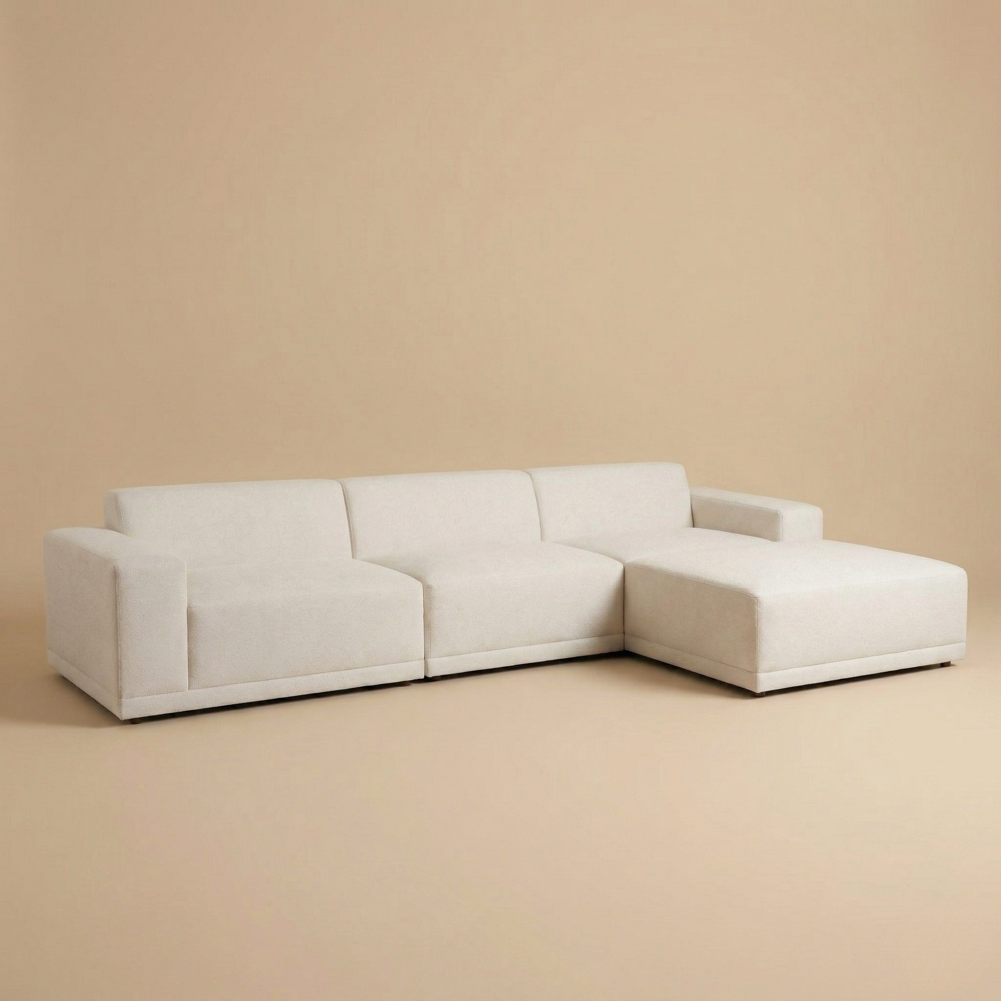 Beige sectional sofa on a beige background