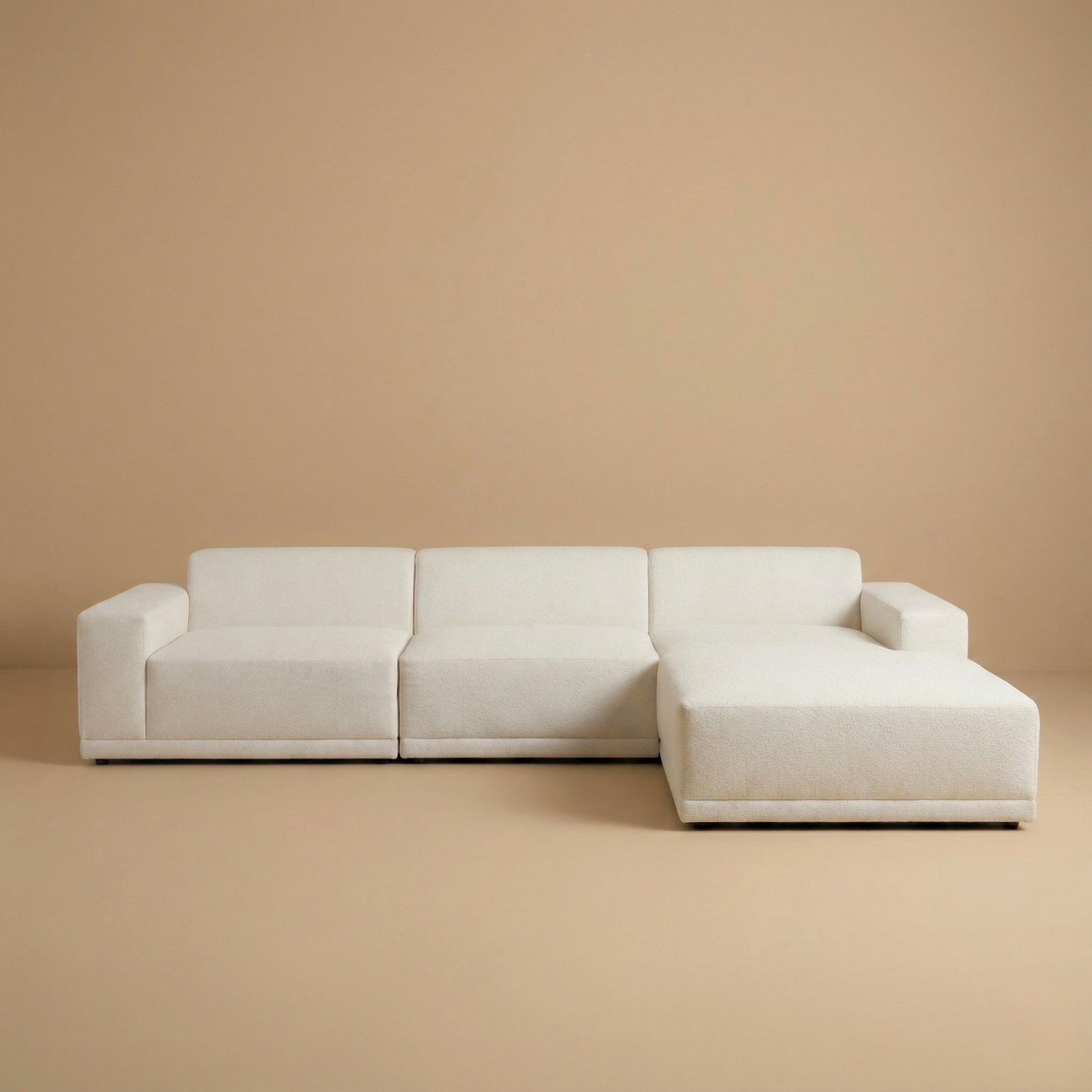 Beige sectional sofa on a beige background