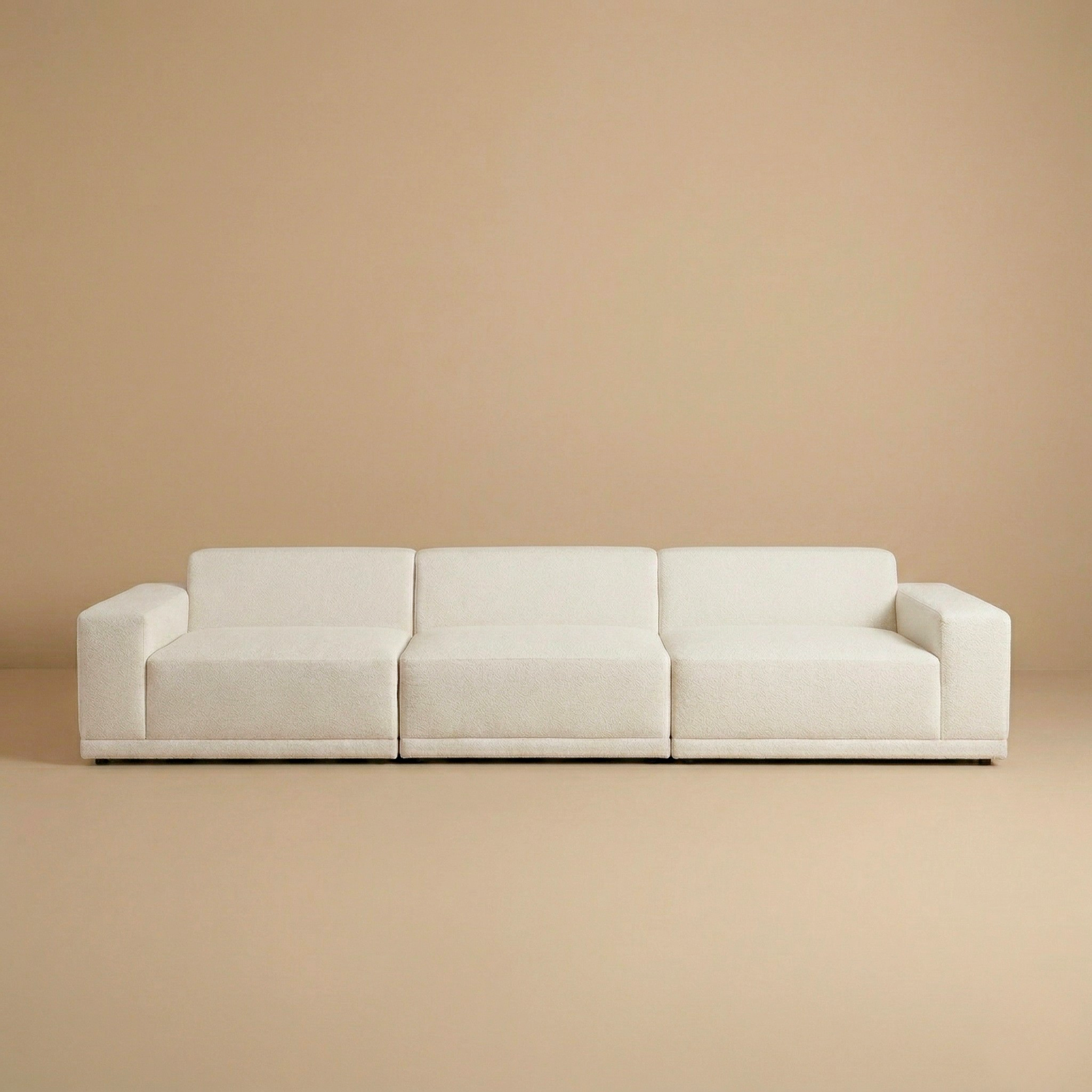 Beige sofa against a matching beige wall