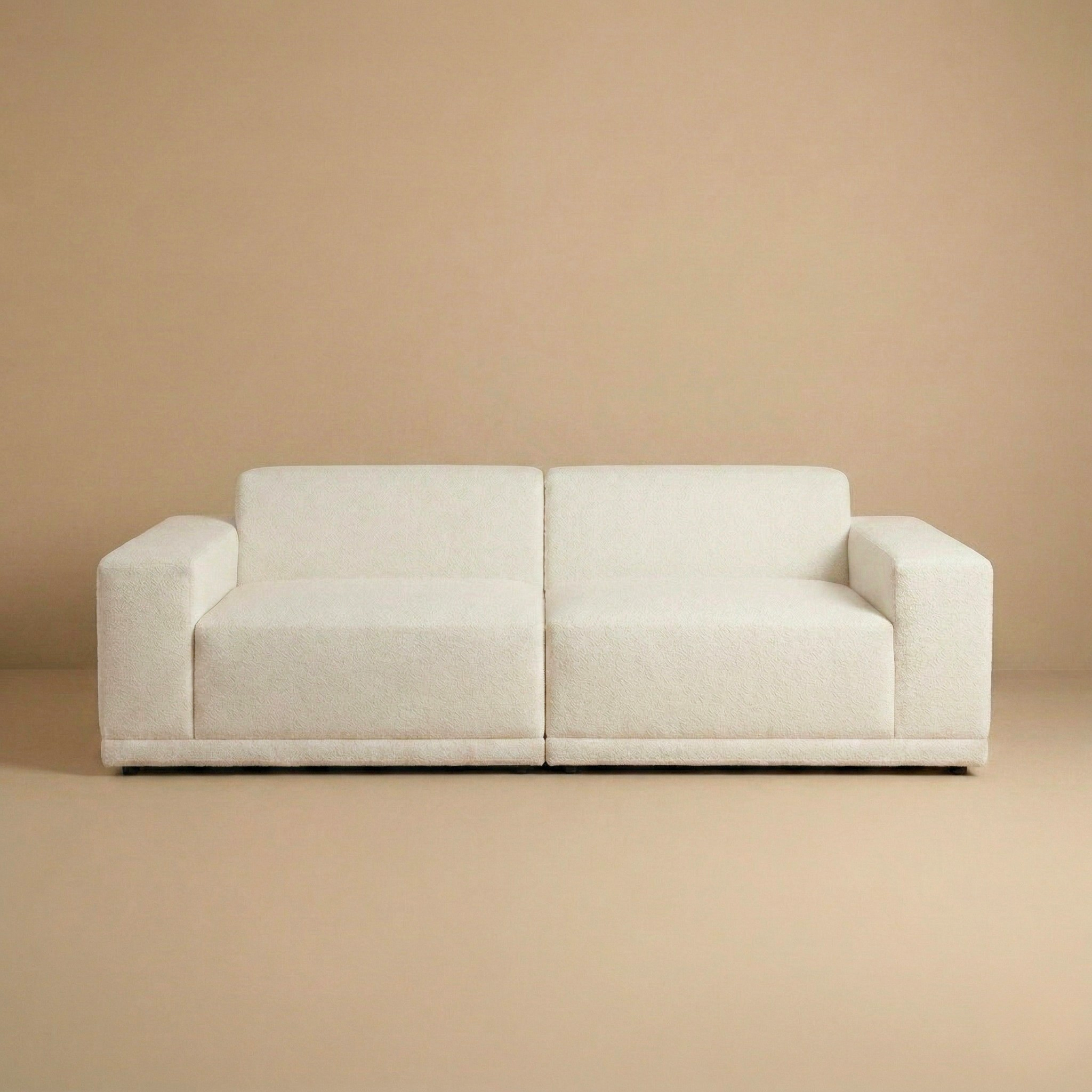 Beige sofa against a matching beige wall
