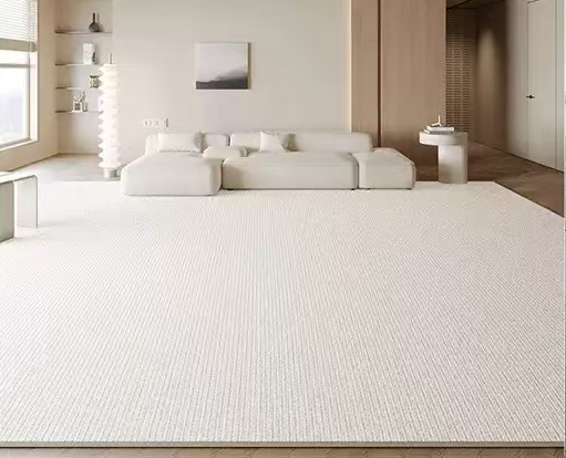 Sophia Rug in a soft cream tone styled in a modern living room with a beige sofa, wood accents, and neutral decor