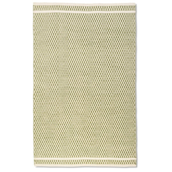 Full overhead view of the rectangular Theo hand-woven wool rug in sage green and cream with a textured geometric design.