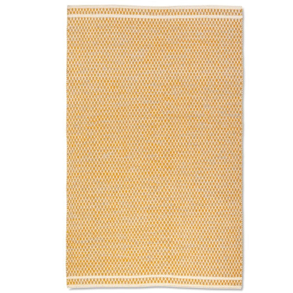 Full overhead view of the rectangular Theo hand-woven wool rug in mustard yellow and cream with a geometric design.