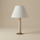 Full view of the unlit Tivoli travertine table lamp featuring a cylindrical stone body, brass base, and white tapered shade.