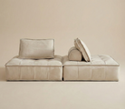 Beige sofa with cushions on a beige background