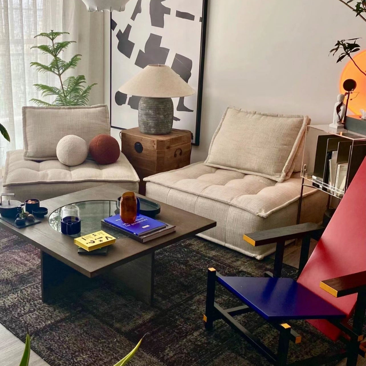 Tofu Modular Sofa in linen fabric styled in modern artistic living room with abstract wall art, colorful accents, and dark coffee table