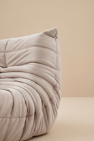 Close up detail of the pleated fabric folds and stitching on the corner of the TOGO Lounger sofa.