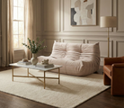 TOGO Lounger two-seater styled in a modern living room with a marble coffee table and neutral rug.