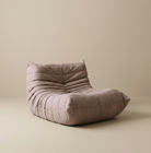 TOGO Lounger single seater in neutral taupe suede showing soft pleated texture and ergonomic shape.