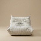 TOGO Lounger single seater chair in white suede featuring iconic pleated design and low profile.