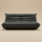 Black leather sofa on a beige background