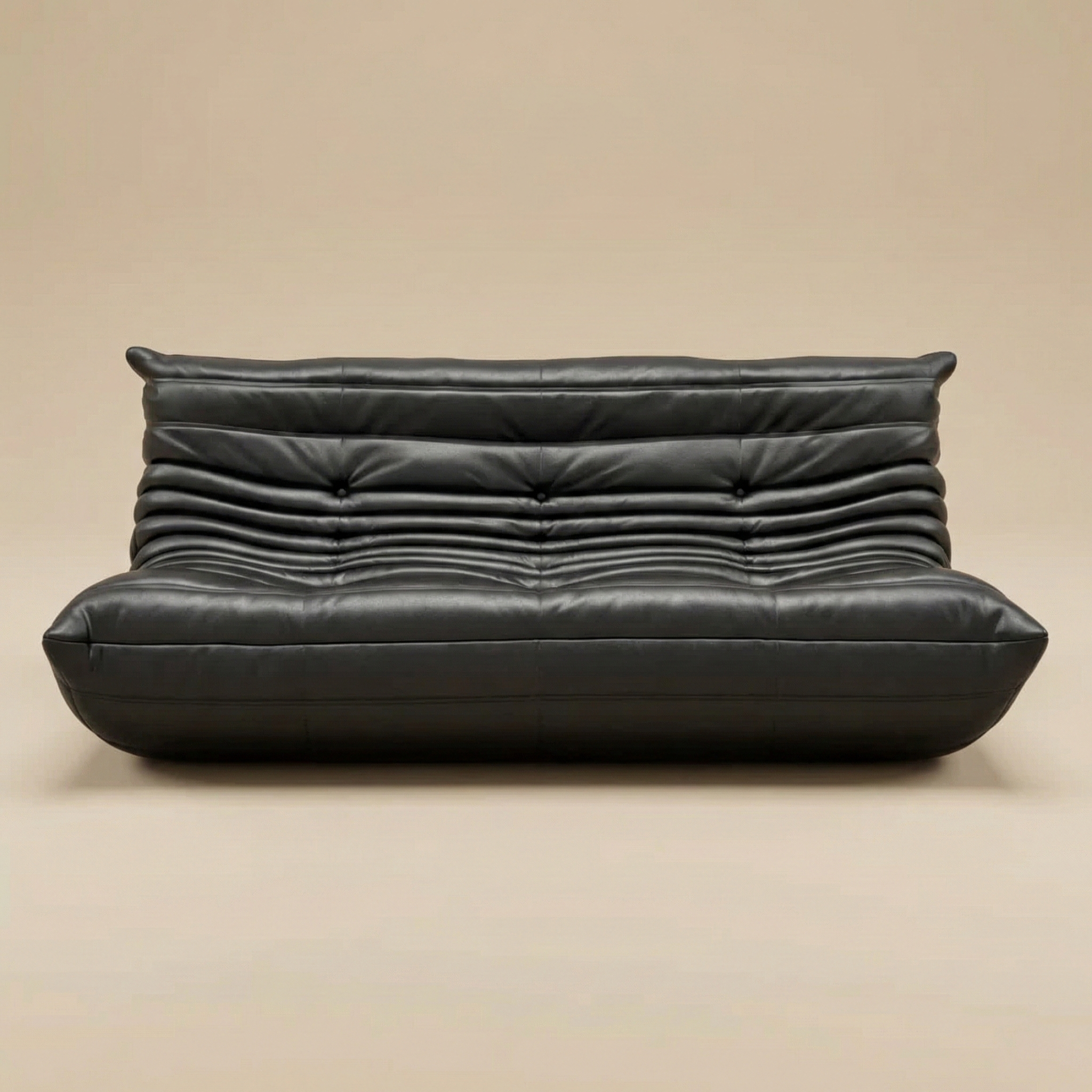 Black leather sofa on a beige background