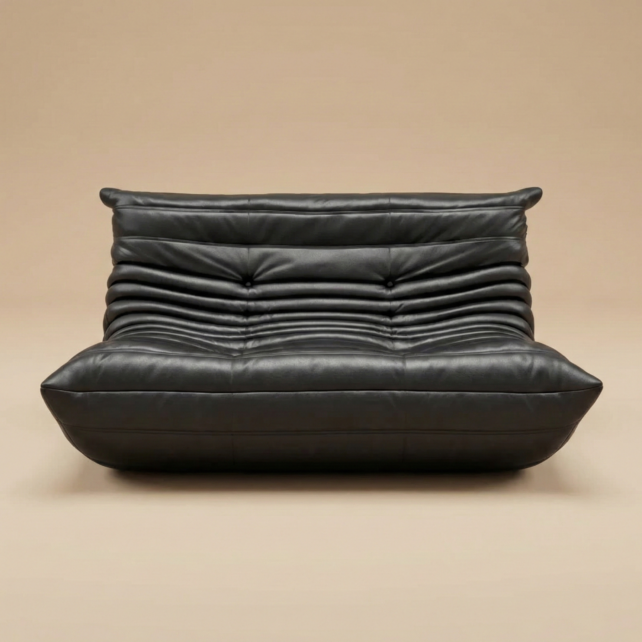 TOGO Lounger two-seater sofa in black leather featuring iconic pleated design and low floor profile.