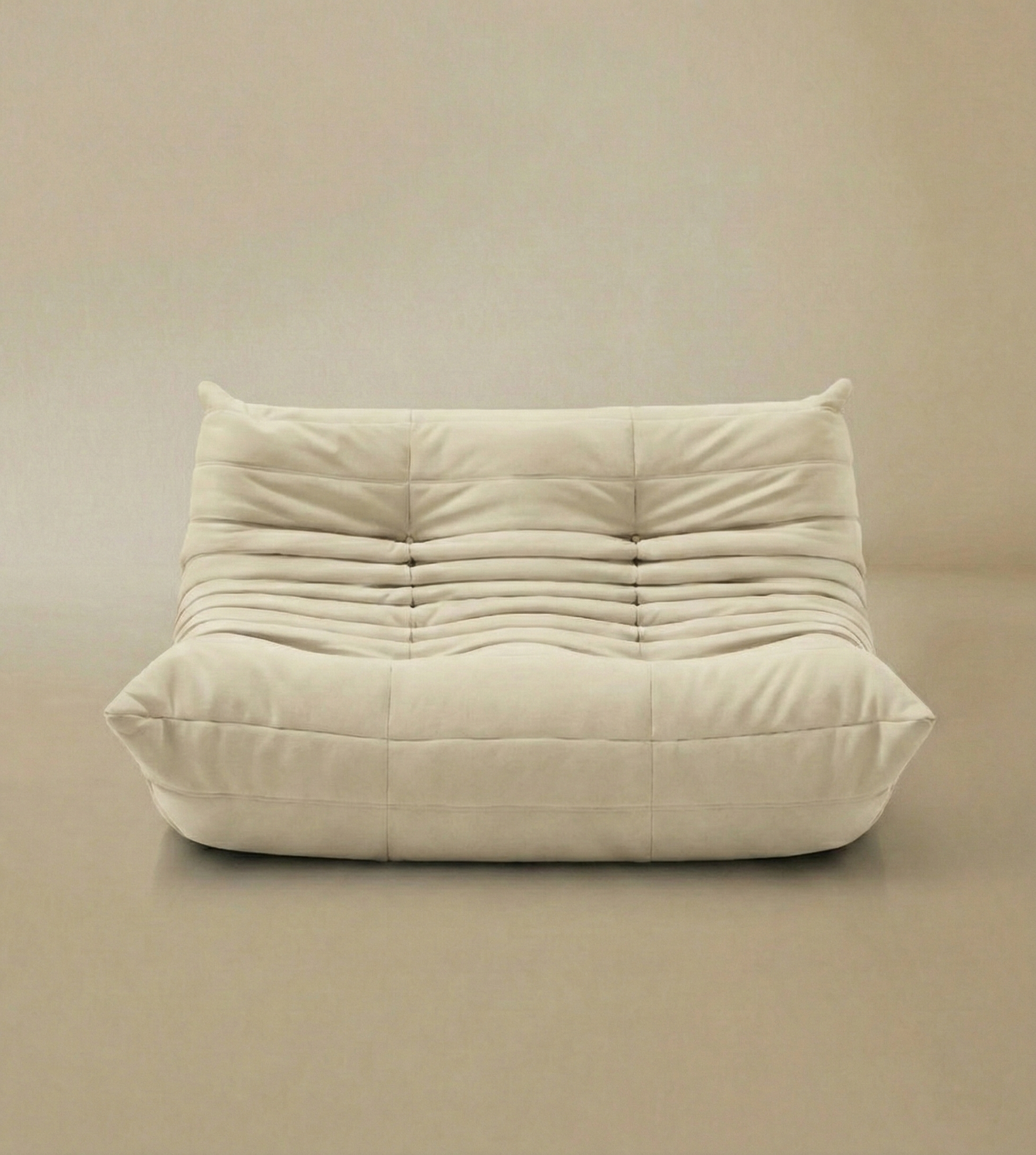 Front view of TOGO Lounger two-seater in cream velvet fabric with soft pleated texture.