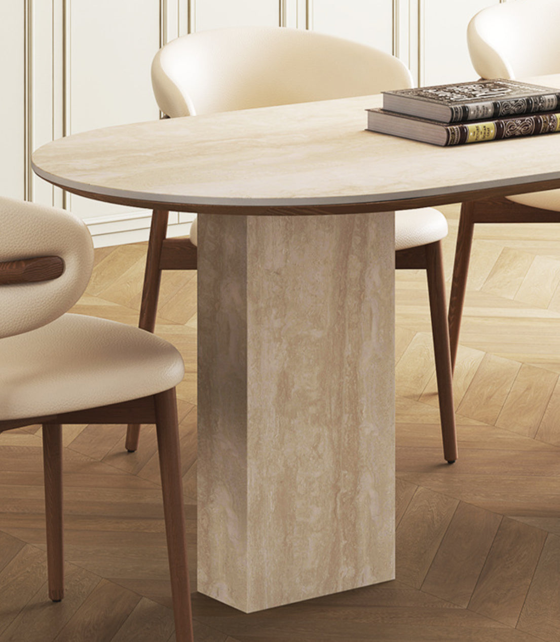 Close-up of travertine sintered stone dining table with rectangular stone leg and cream chairs on wood floor