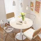 Tulip Dining Table placed in a bright corner with tulip flowers and mixed chairs, creating a warm and airy breakfast nook