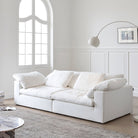 Ultra Softness Modular Cloud Sofa in natural linen with plush cushions styled in a bright living room with arched window and modern decor