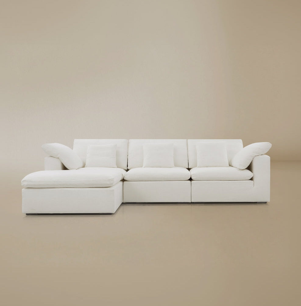 Front view of the modular cloud sofa on a beige studio background.