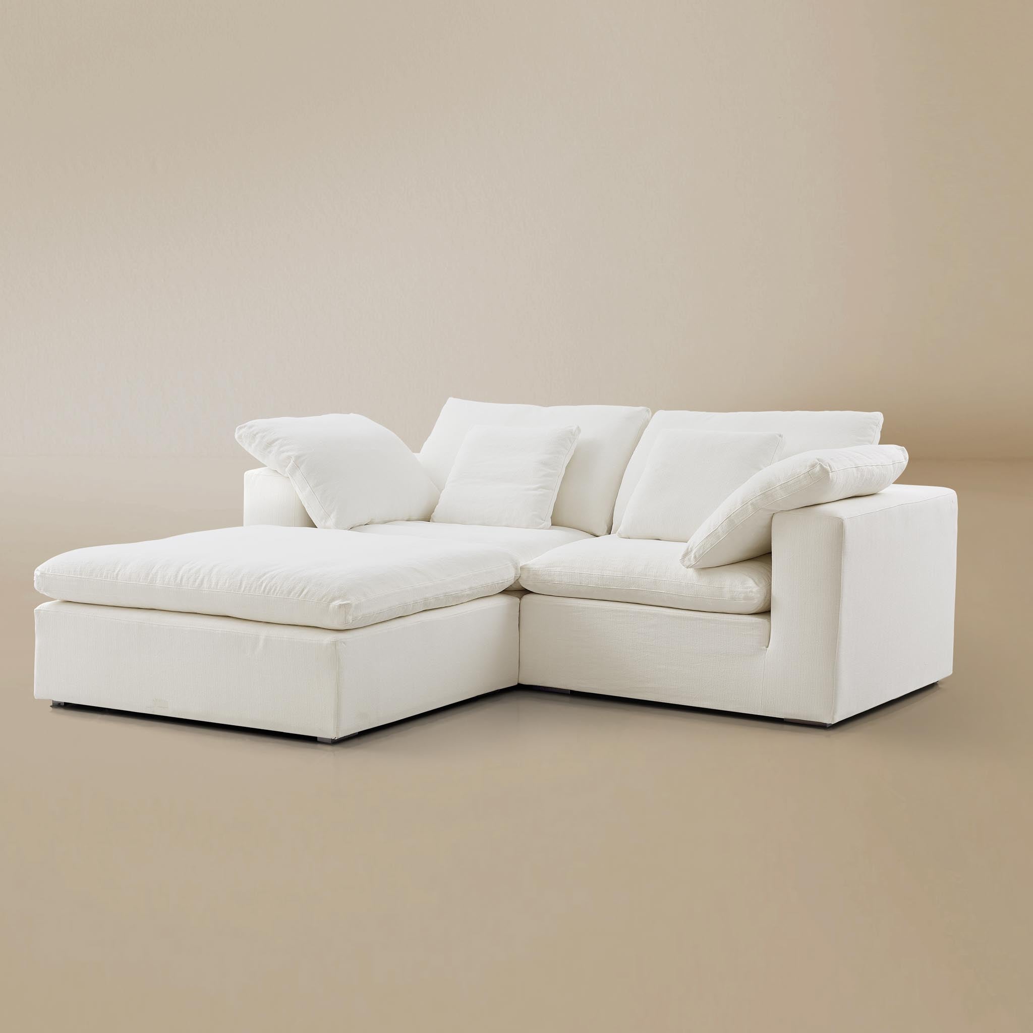 Ultra softness modular sofa two seater with ottoman on a beige studio  background
