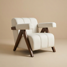 Vanguard Modern Accent Chair featuring iconic V-shaped solid wood legs and cream channel-tufted upholstery with bolster arms.