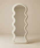 Wavy Floor Full Body Mirror with sculptural curved frame in a neutral minimalist setting.