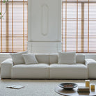 Front view of Whisper Breathable Cotton Sofa 2 seater in white breathable cotton muslin fabric styled in a minimalist living room with soft natural light and neutral tones