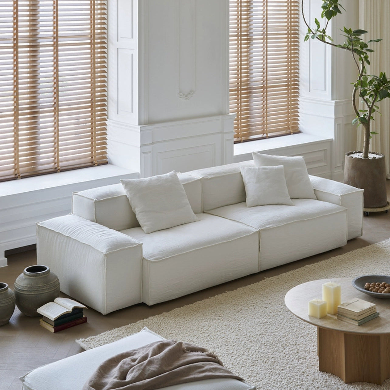 Whisper Breathable Cotton Sofa 2 seater in white breathable cotton muslin fabric styled in a bright minimalist living room with neutral décor and natural light