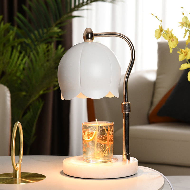 White Lily Adjustable Height Candle Warmer in a living room setting with lit candle under white dome shade.
