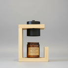 Wooden Frame Modern Candle Warmer Lamp with black heat shade and amber jar candle on display.