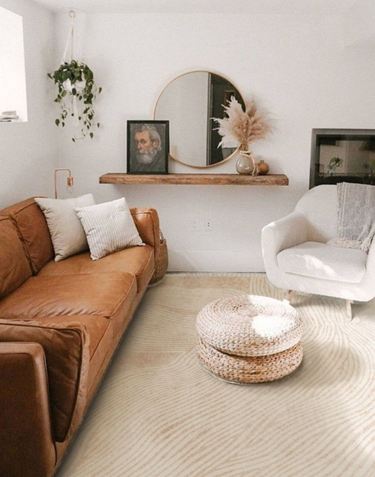 Cozy living room styled with the Woven Whisper Rug, paired with a tan leather sofa, white accent chair, and woven ottoman