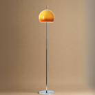 Yellow Dome Glass Standing Floor Lamp with chrome base and stem against warm beige background